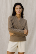 Woman wearing Jesie-London Elizabeth women's winter V-neck knit sweater, cozy wrap design, in a casual indoor setting.