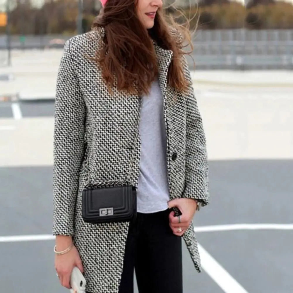 Women’s vintage-inspired houndstooth coat by Jesie-London, featuring classic pattern and tailored fit, worn by a model outdoors.