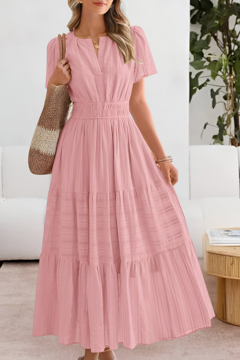 Jesie-London Alice women's boho short sleeve smocked midi dress displayed on a hanger with floral patterns and flowing fabric.