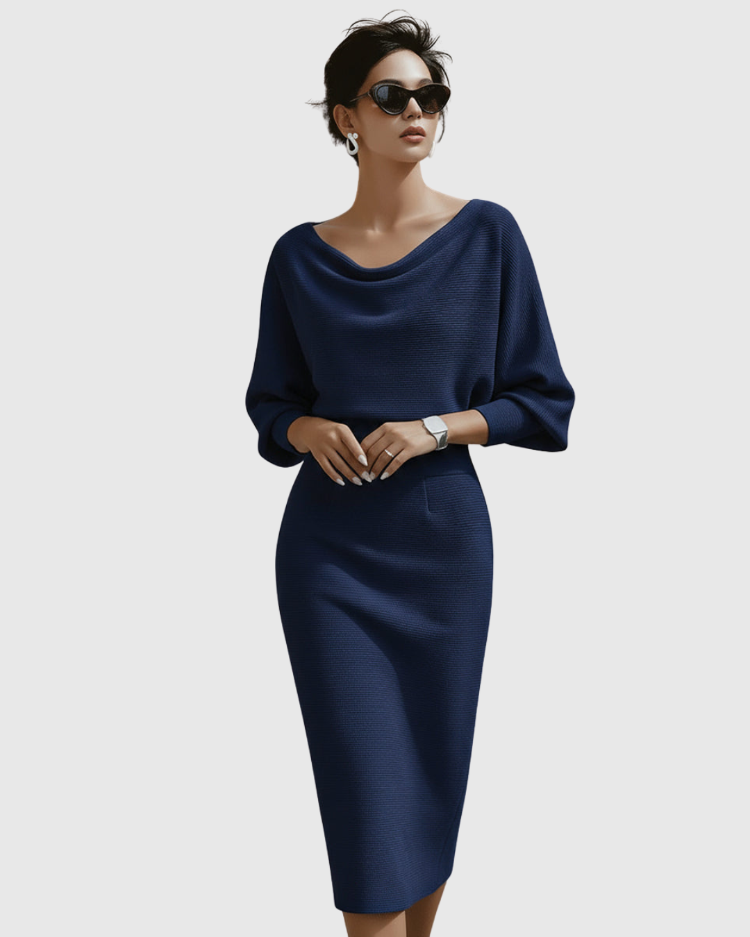 Jesie-London Grace women's elegant draped knit midi dress displayed on a mannequin showing the pleated fabric and sophisticated style.