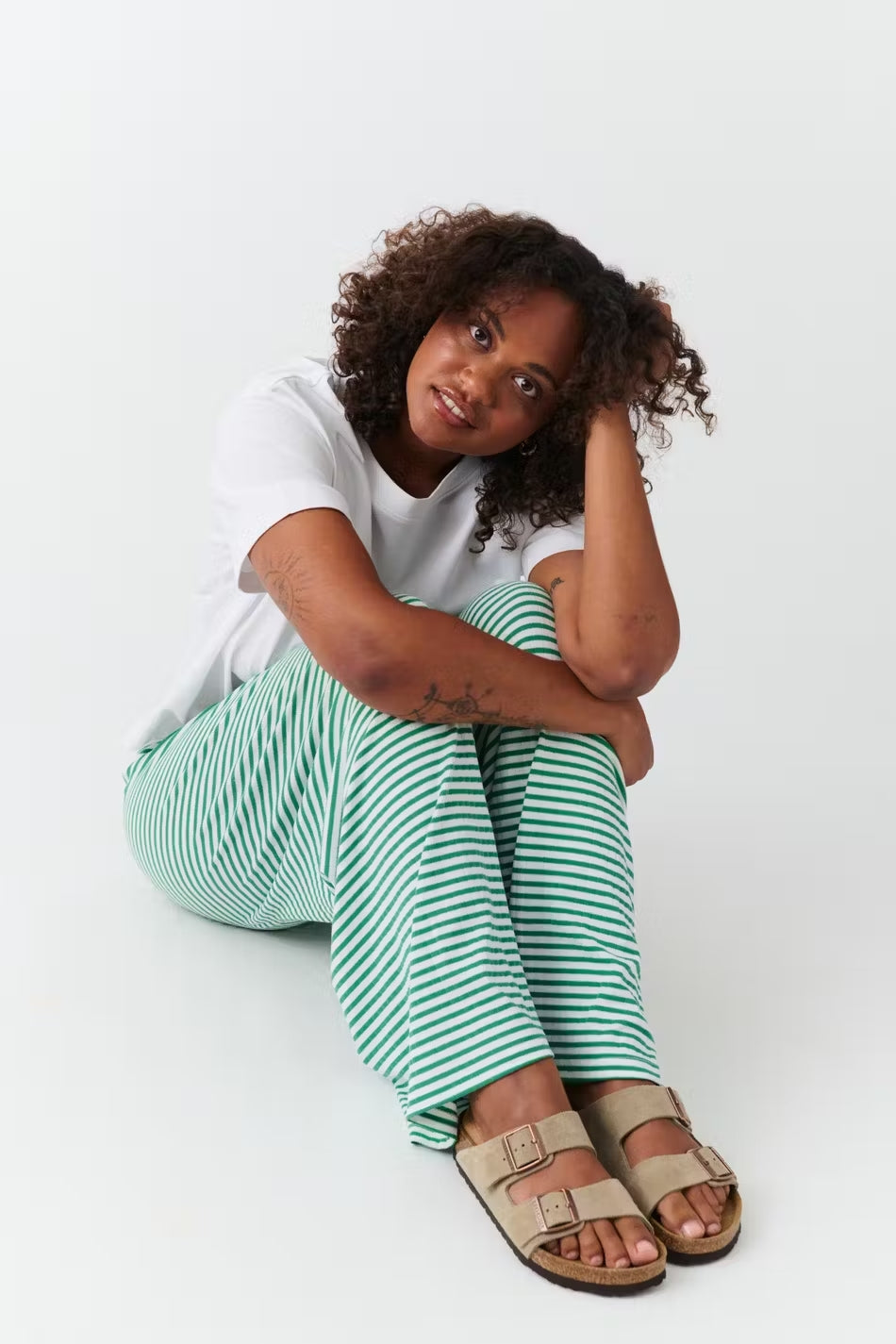 A woman wearing Jesie-London Ava women's spring striped relaxed pants, featuring a comfortable fit and stylish pattern.