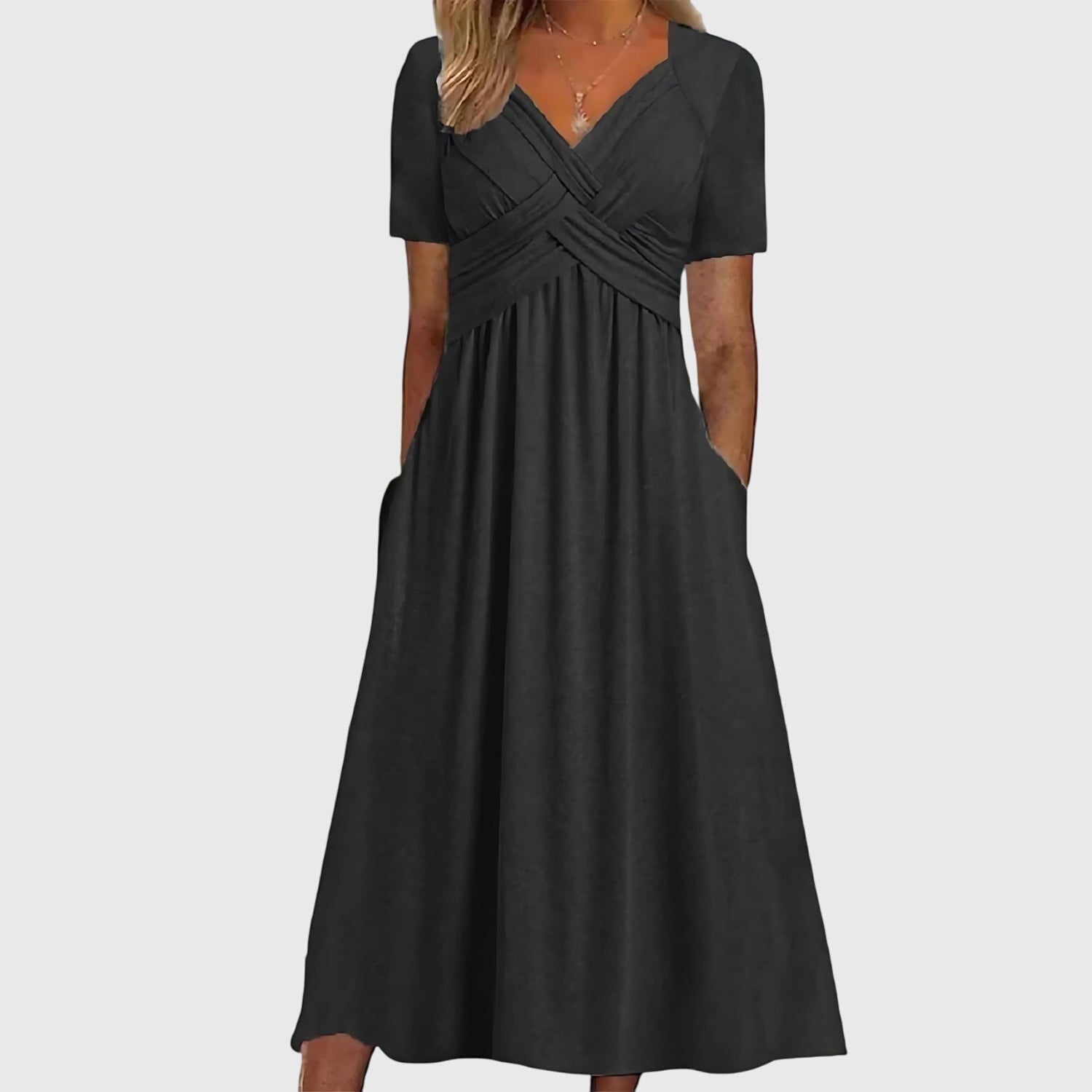Jesie-London Megan women's v-neck flowy midi dress hanging on a wooden hanger, showcasing its lightweight fabric and elegant silhouette.