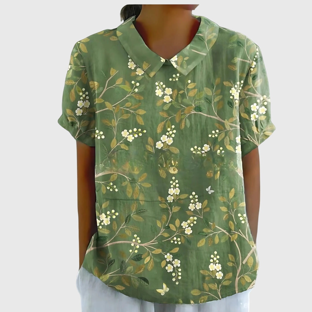 Women's floral collar short sleeve blouse by Jesie-London, featuring a feminine design with vibrant floral pattern.