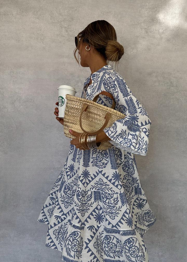 Jesie-London Bethany women's boho patterned long sleeve mini dress with a flowing kaftan-chic style, displayed on a hanger.