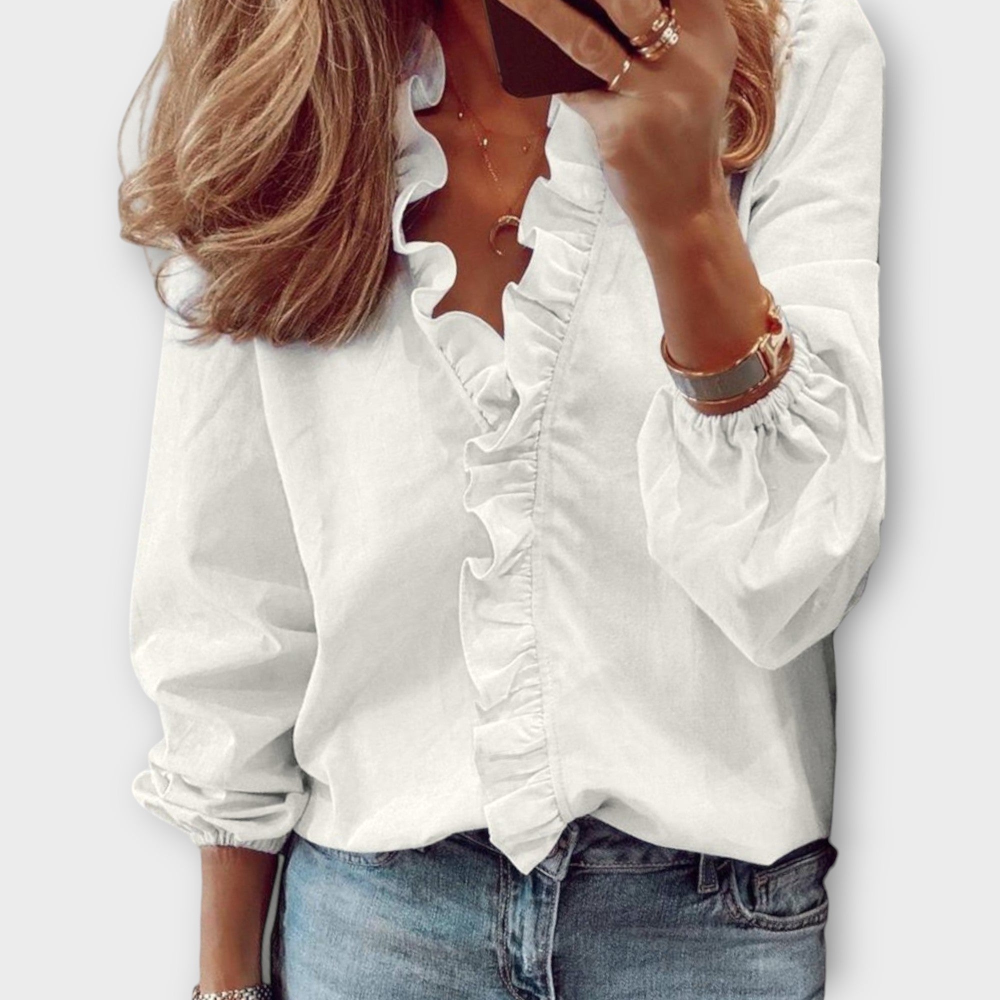 Women’s ruffle V-neck long sleeve blouse by Jesie-London, in soft fabric with feminine ruffle details and a relaxed fit.