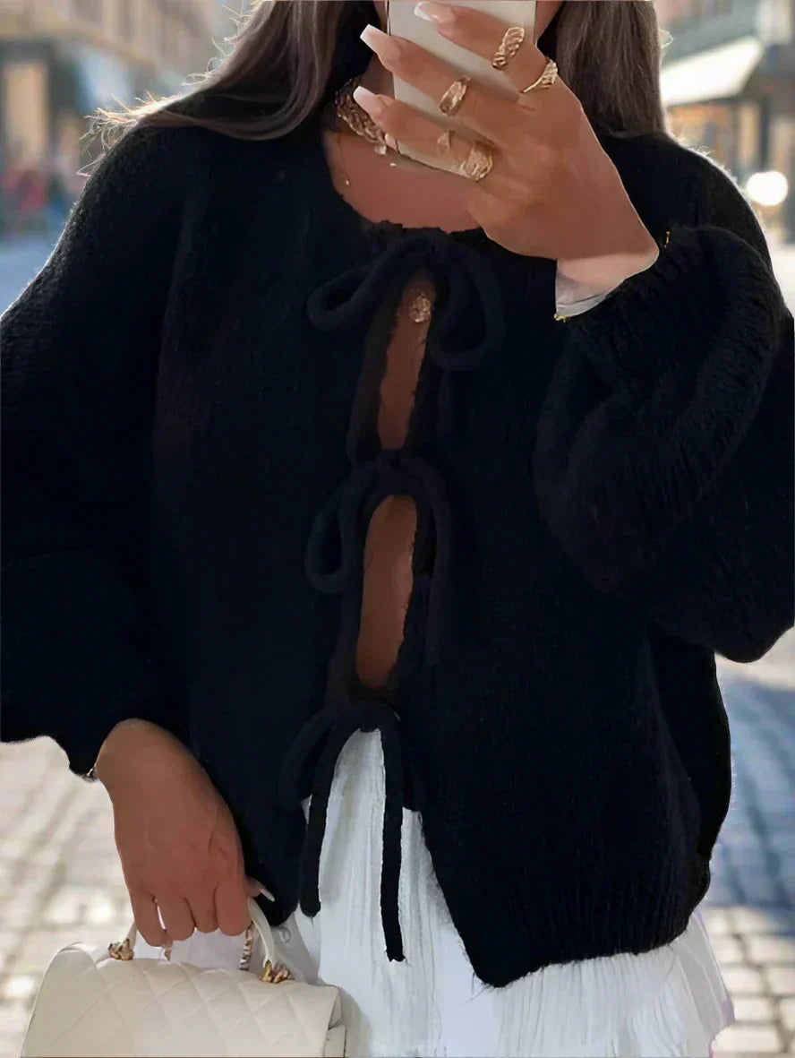 Black women's knit cardigan with bow ties from Jesie-London, featuring soft, cozy knit fabric and a relaxed fit.
