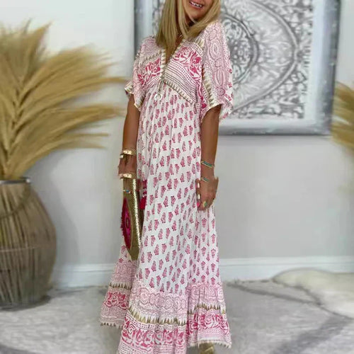 Jesie-London Amelia women's boho maxi dress with tassel details, short sleeves, and flowing fabric in a stylish design.