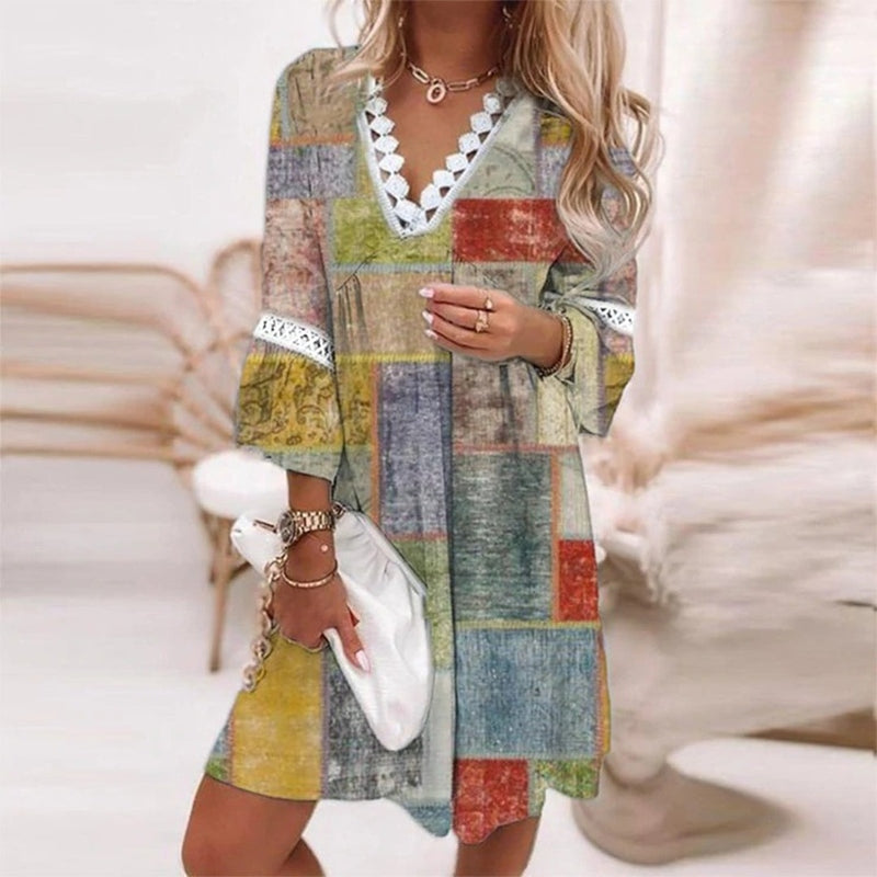 Women's boho floral V-neck mini dress by Jesie-London featuring colorful patterns and a relaxed summer style.