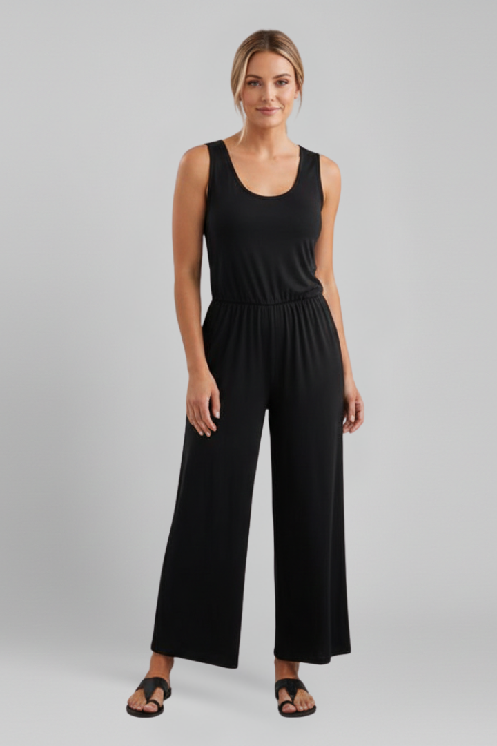 Women’s Stella jumpsuit with round neckline, elastic waist, wide-leg design, by Jesie-London, shown on a model in a casual pose.