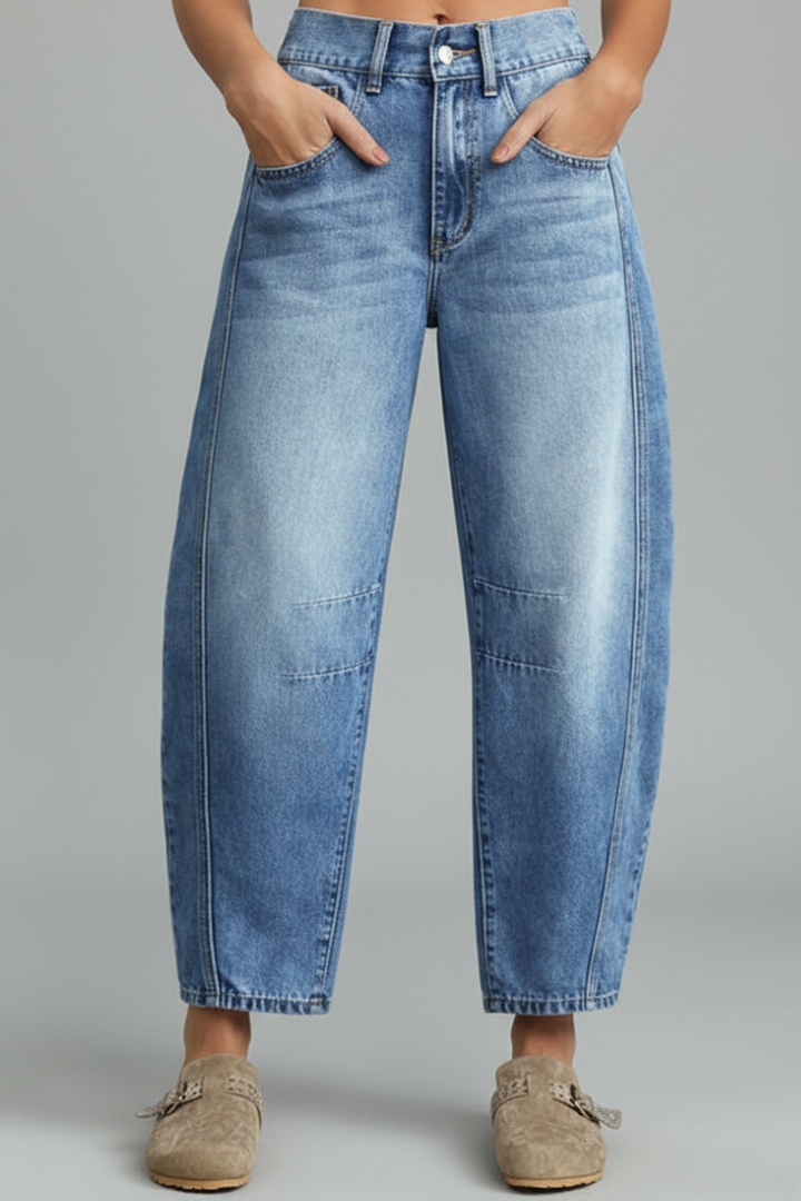 Jessica women’s casual mid-waist denim jeans with front closure and pockets, styled on a model with a relaxed fit.