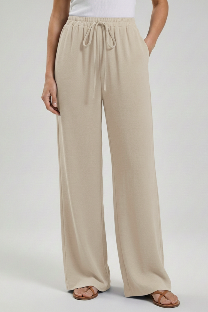 Jesie-London Catherine women's palazzo trousers with drawstring waist and side pockets, full-length, lightweight fabric.