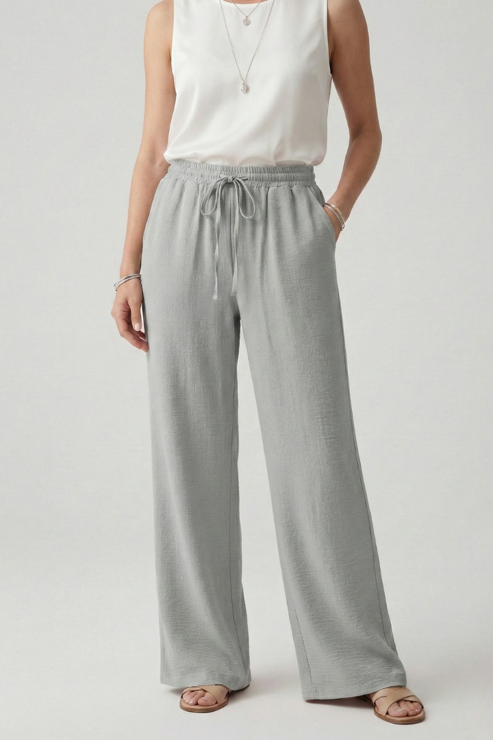 Blue Jesie-London Bella women’s casual palazzo trousers with drawstring waist and side pockets, shown on a model.