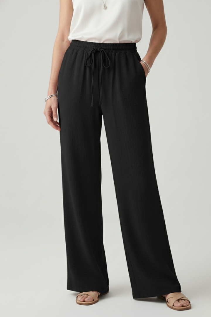 Jesie-London Bella women's casual palazzo trousers with drawstring waist and side pockets, made from lightweight fabric.