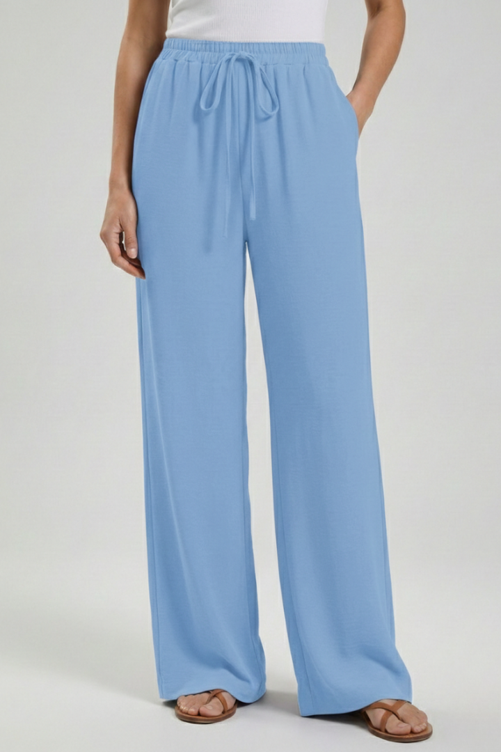 Jesie-London Catherine women's palazzo trousers with drawstring waist and side pockets, relaxed fit and lightweight fabric.