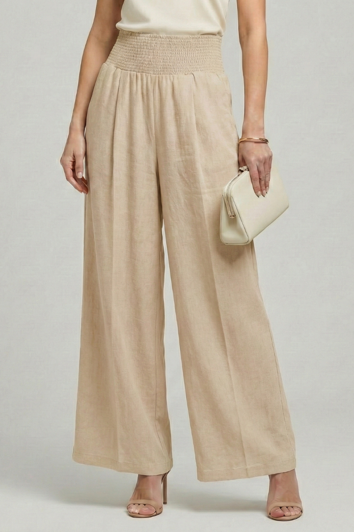 Jesie-London Bethany women’s high-waist palazzo trousers with elegant pleats, styled with a relaxed fit and wide-leg design.