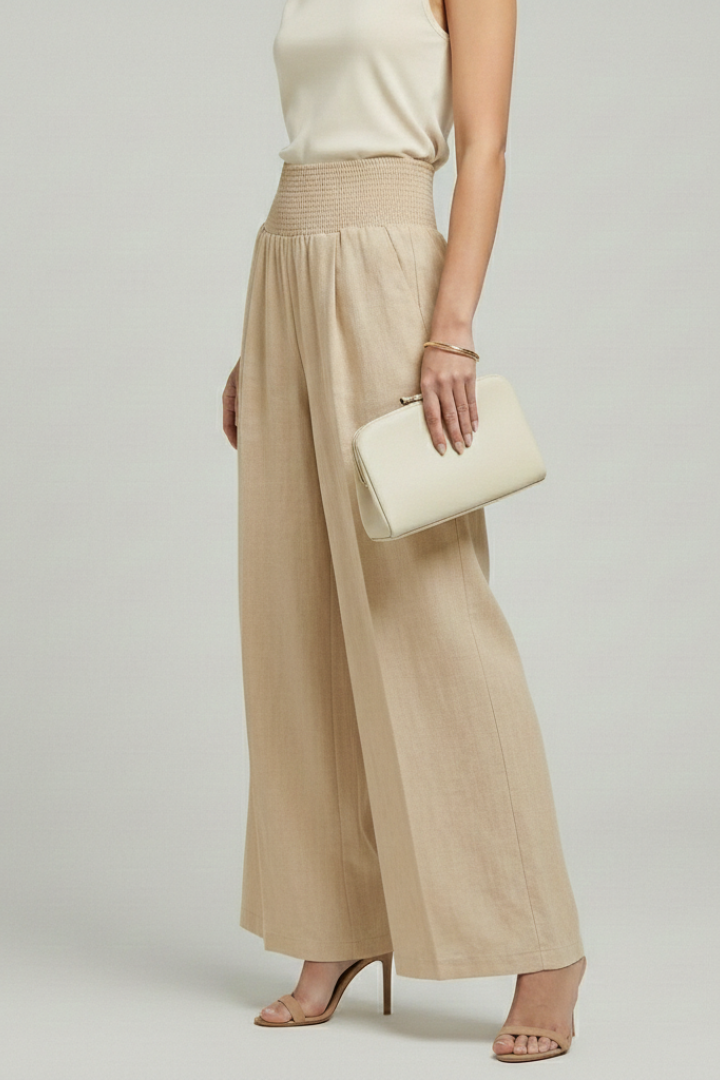 Women’s palazzo trousers by Jesie-London featuring high waist and pleats, styled for a comfortable, elegant look.
