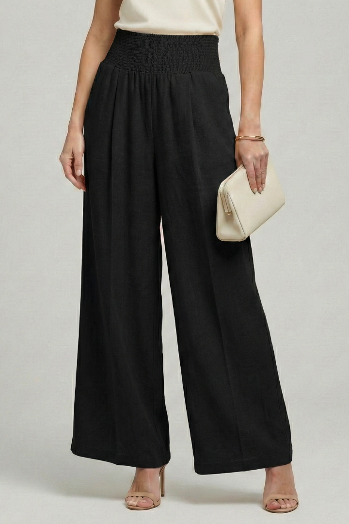 Women’s high waist palazzo trousers with pleats by Jesie-London, showcasing a flowy, elegant wide-leg design and tailored fit.
