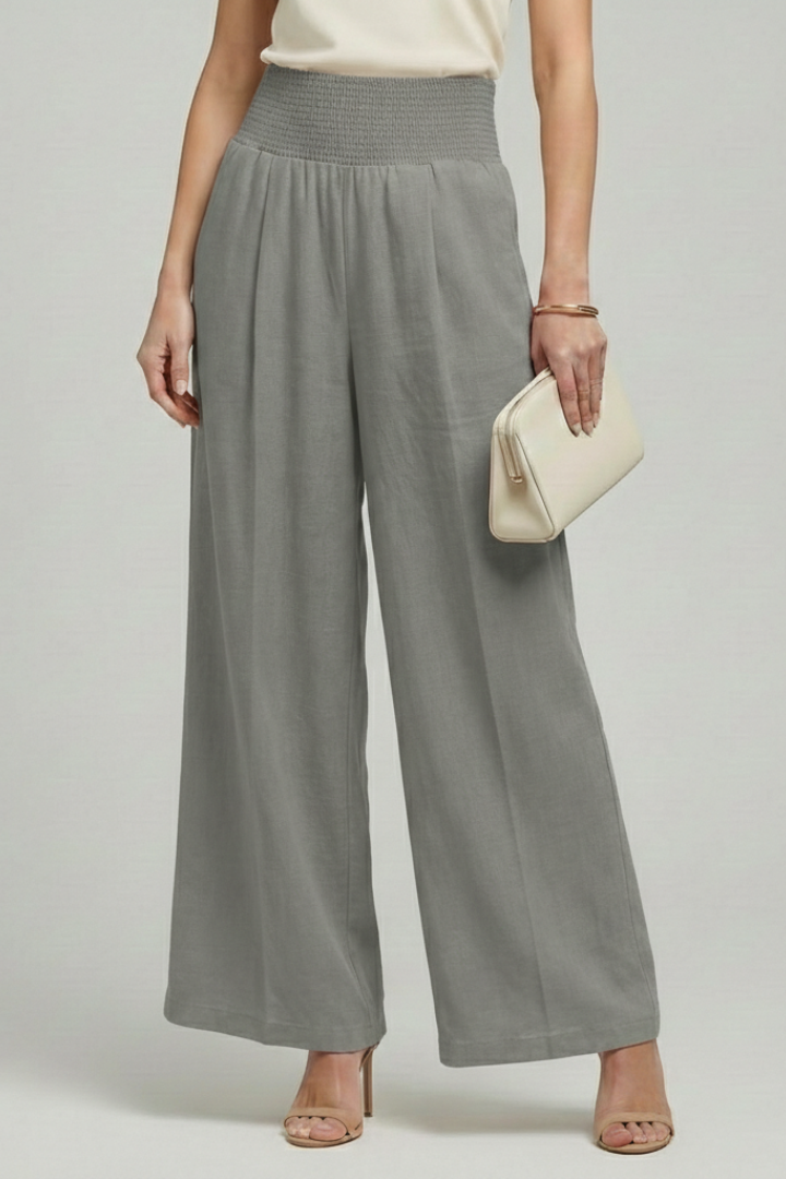 Jesie-London Bethany women's palazzo trousers with high waist, pleats, and wide-leg design, shown on a model.