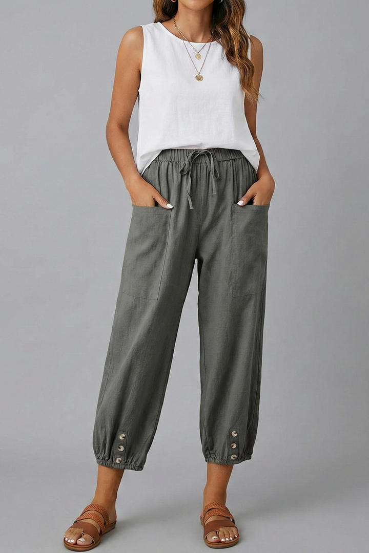 Women’s Amelia trousers by Jesie-London featuring a drawstring waist and button hem, shown in a natural pose.