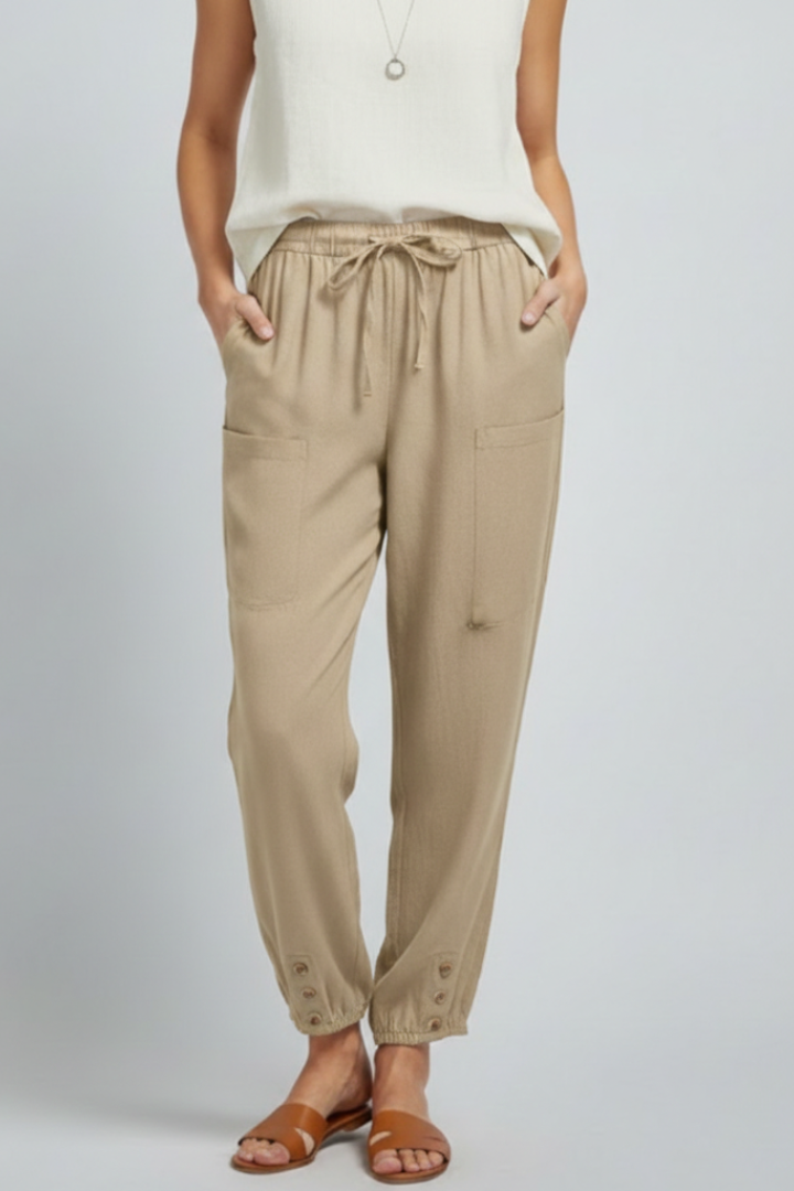 Women’s Jesie-London Amelia trousers with drawstring waist and button hem, shown in a stylish, relaxed fit on a model.
