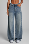 Women’s relaxed wide-leg denim jeans by Jesie-London with front closure and long hem, styled on a woman.