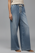 Women’s relaxed wide-leg denim jeans with drawstring waist and long hem from Jesie-London, shown on a model.