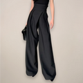 Black women’s high-waisted wide-leg trousers from Jesie-London, tailored fit with elegant, flowing wide-leg design.