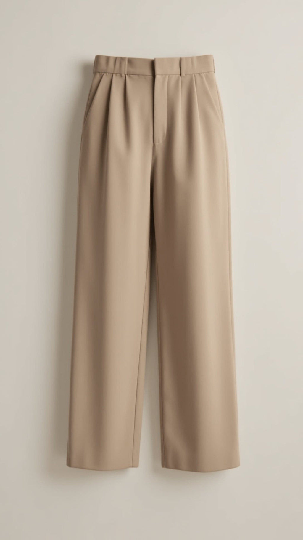 Women’s high-waisted wide-leg trousers with pleated front, styled by Jesie-London, shown in a natural pose.