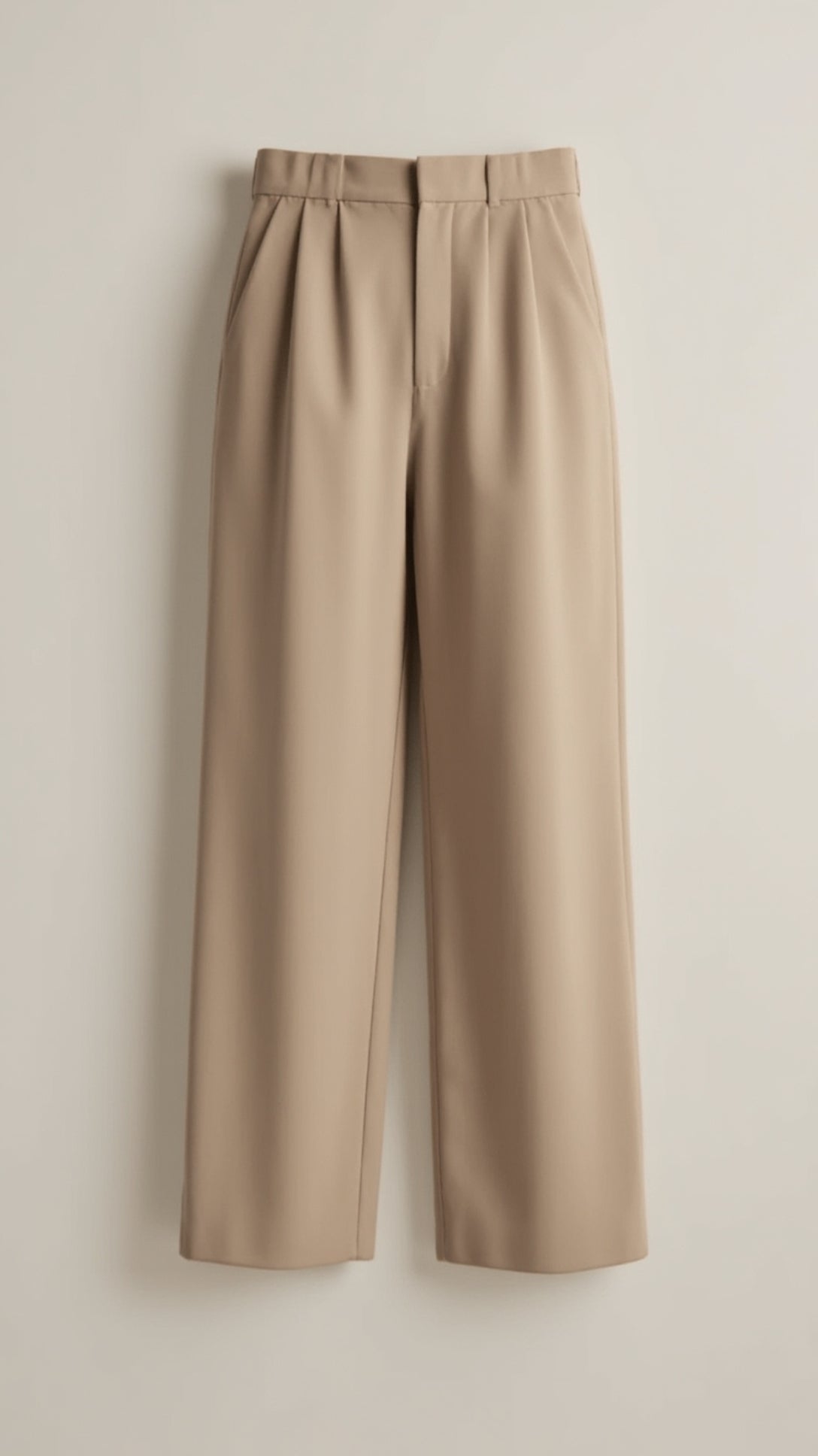 Women’s high-waisted wide-leg trousers with pleated front, styled by Jesie-London, shown in a natural pose.