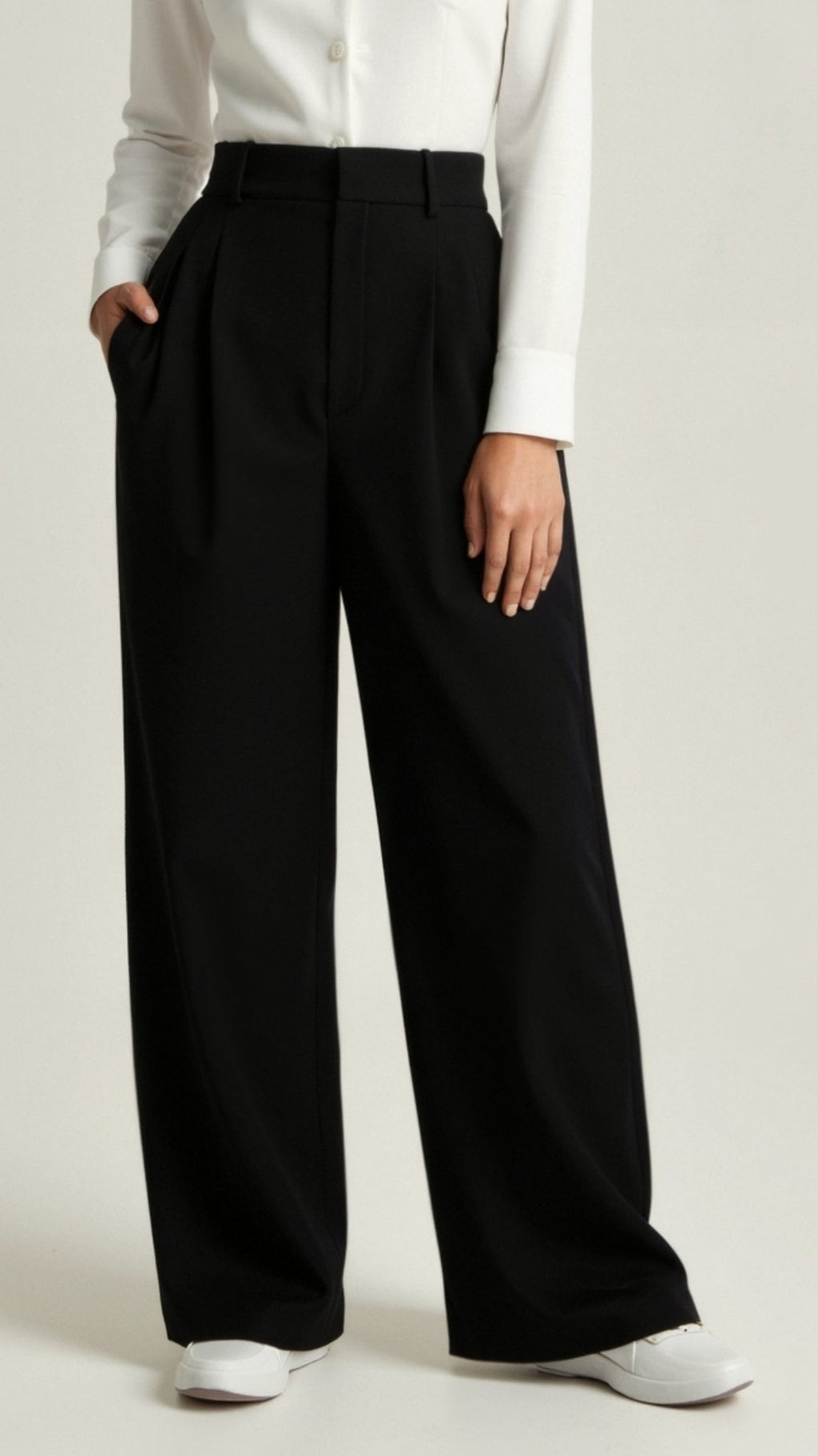 Women’s high waisted wide leg trousers by Jesie-London featuring pleated front and relaxed fit, shown in a neutral color.