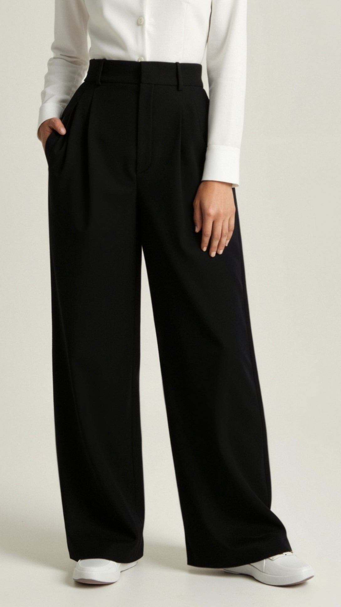 Women’s high waisted wide leg trousers by Jesie-London featuring pleated front and relaxed fit, shown in a neutral color.