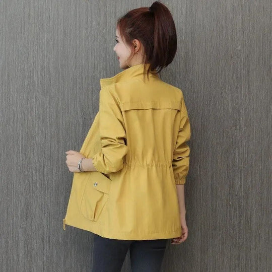 Women’s khaki lightweight waterproof trench coat by Jesie-London, casual style with adjustable waist, mid-length, loose fit.