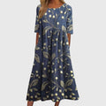 Jesie-London Ruby women's vintage floral midi dress featuring a fitted bodice and flowing skirt with vibrant floral print.