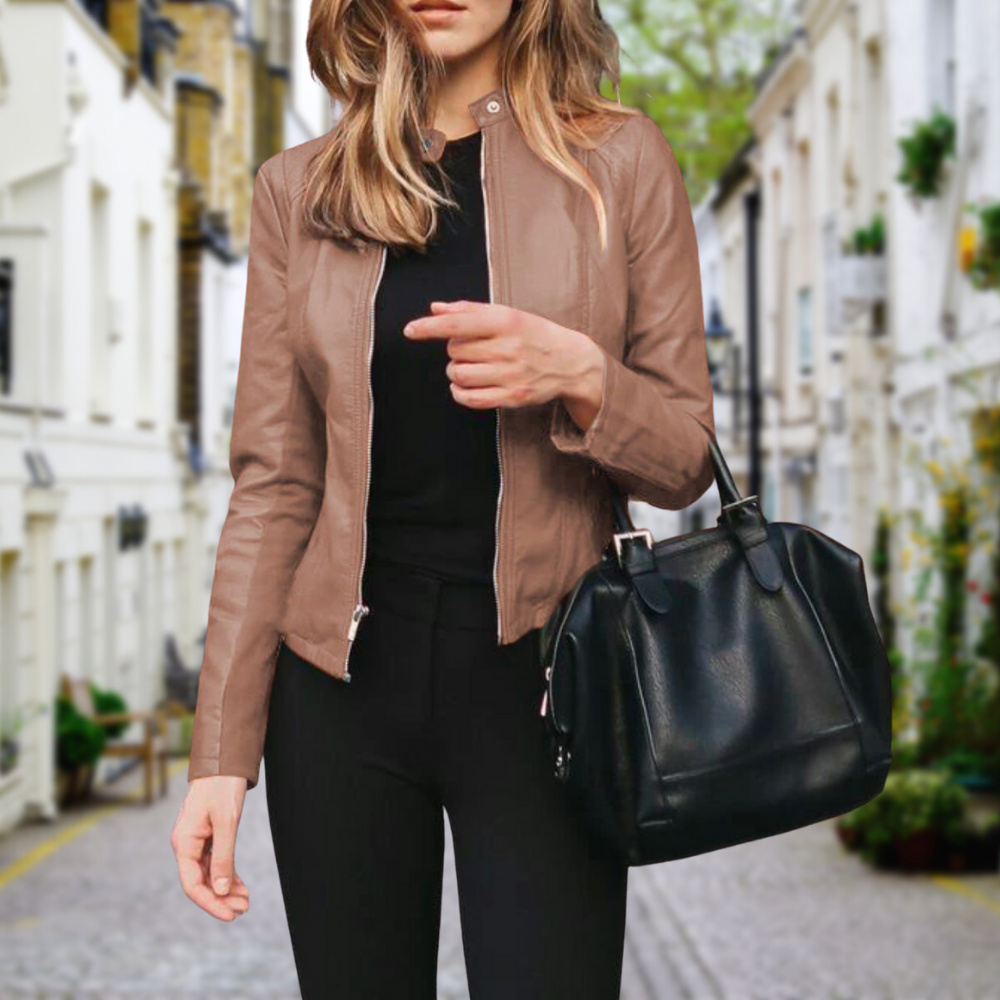 Women’s slim fit brown leather zip-up casual jacket by Jesie-London, shown with a black handbag in the front view.