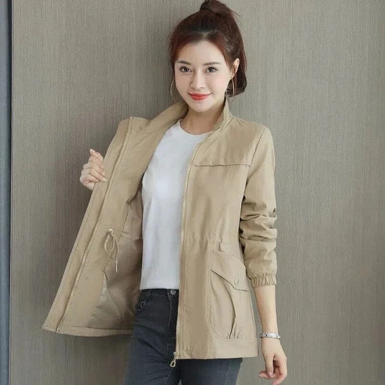 Women’s lightweight waterproof trench coat by Jesie-London, khaki color, mid-length, adjustable waist, casual and windproof for spring.
