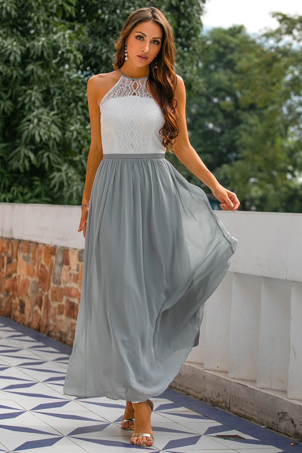 Light grey women's halter maxi dress with open back for wedding guests, styled for elegant occasions.