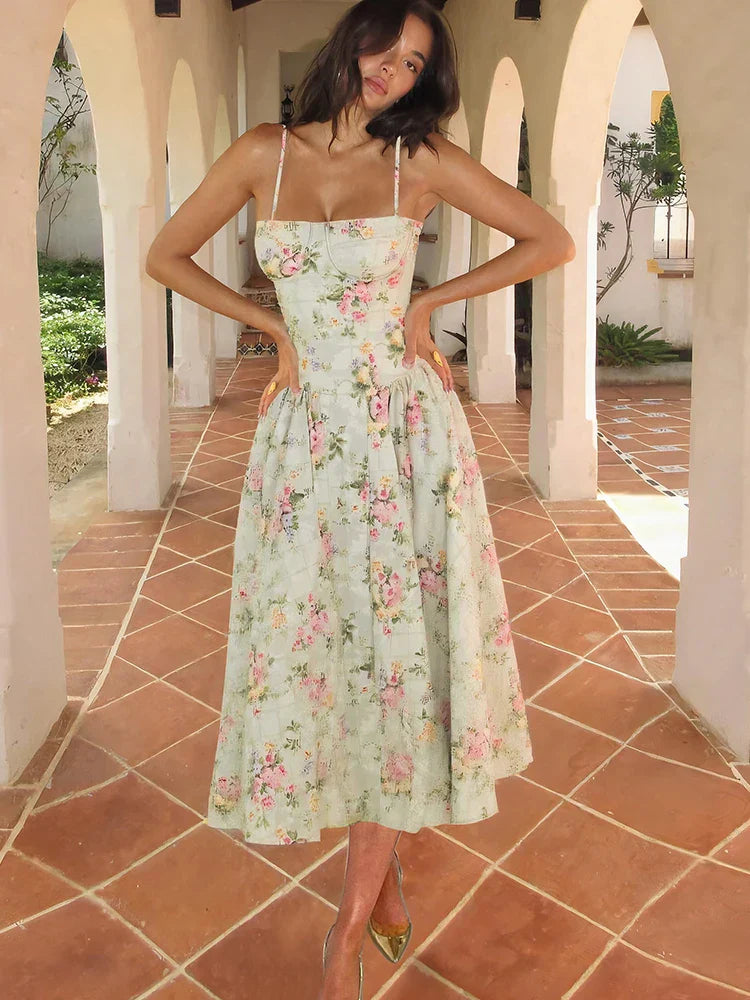 Women’s sleeveless floral strap midi wedding guest dress by Jesie-London, featuring a fitted corset style and elegant midi length.