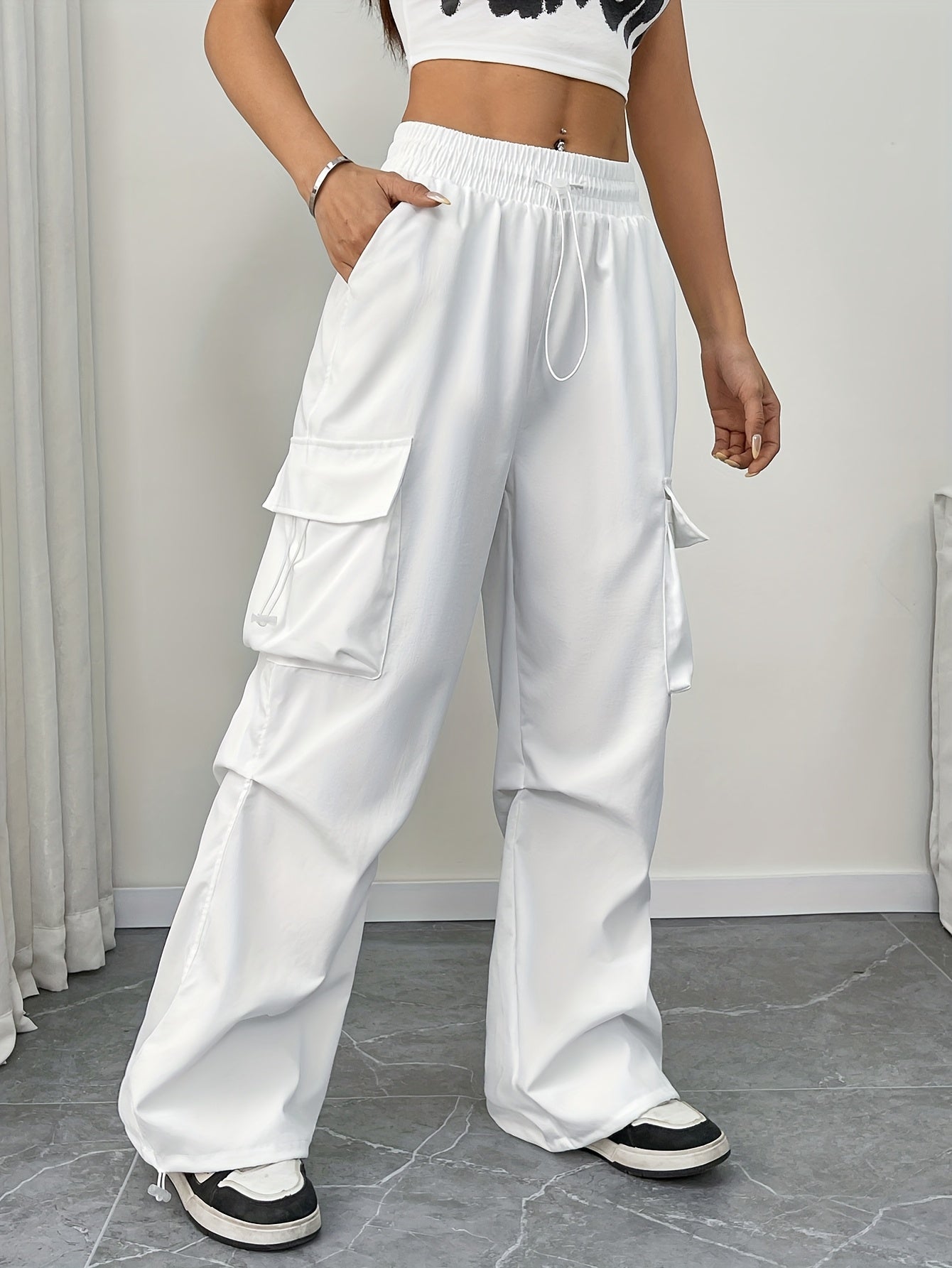 Women's wide-leg cargo pocket drawstring pants by Jesie-London, featuring a relaxed parachute style and adjustable waist.