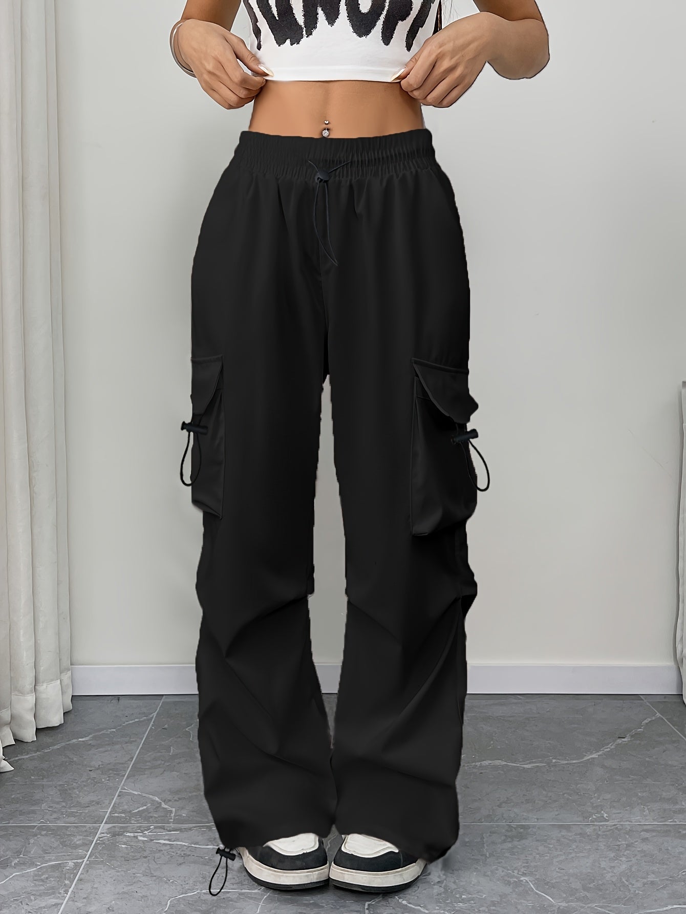 Women’s wide-leg cargo pants with drawstring waist and cargo pockets by Jesie-London, shown in a stylish parachute fit.