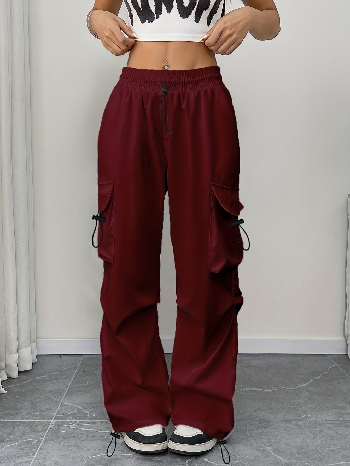 Women's wide-leg cargo pocket drawstring pants by Jesie-London, featuring a relaxed parachute fit and adjustable waist.