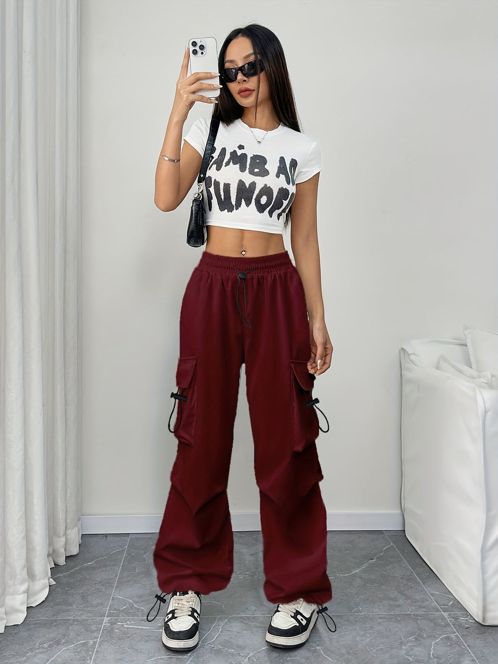 Women's wide-leg cargo pants with drawstring waist and multiple cargo pockets by Jesie-London, shown in a parachute style.