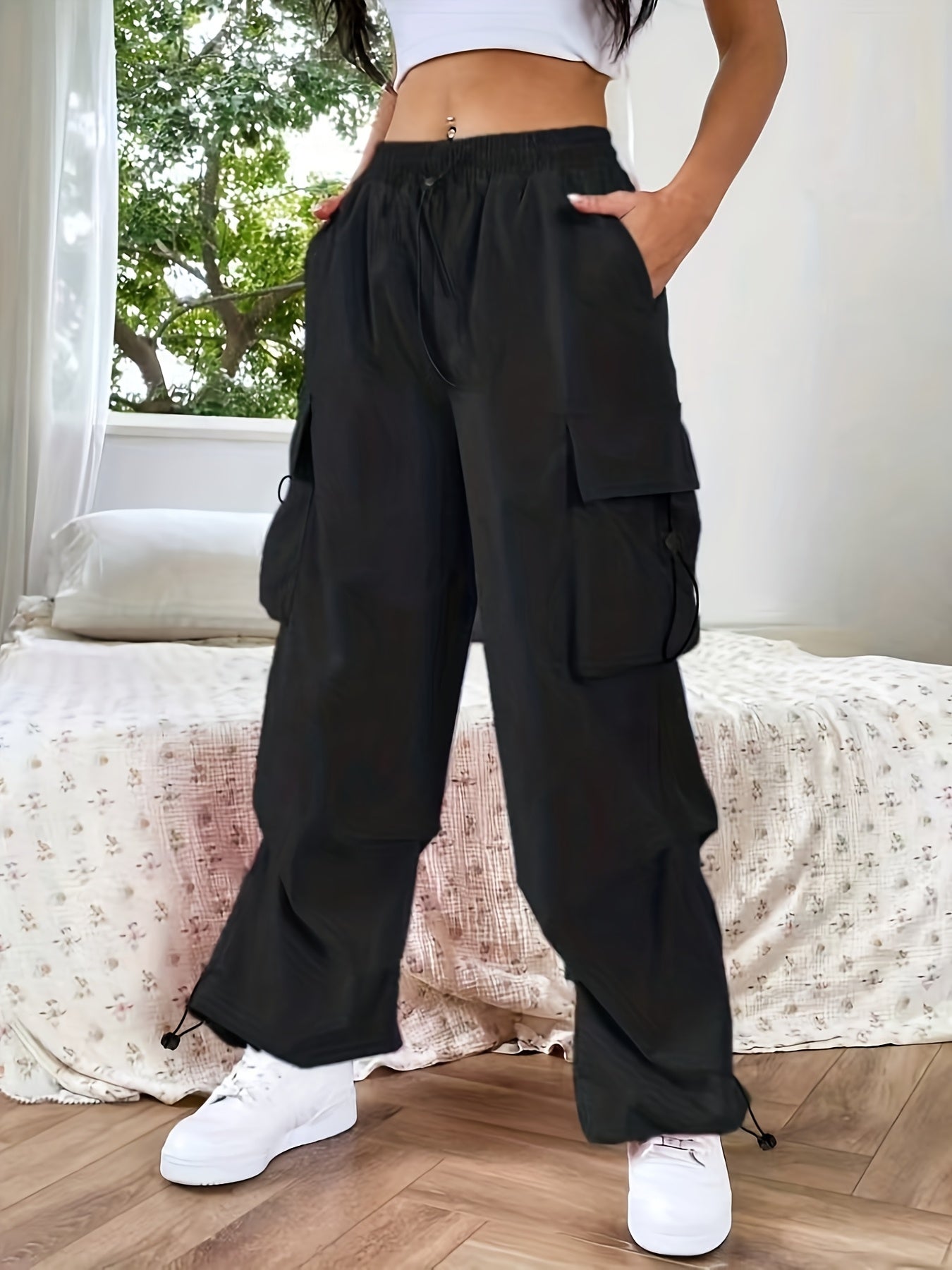 Women's wide-leg cargo pants by Jesie-London featuring casual, loose fit with multiple cargo pockets and parachute-style design.