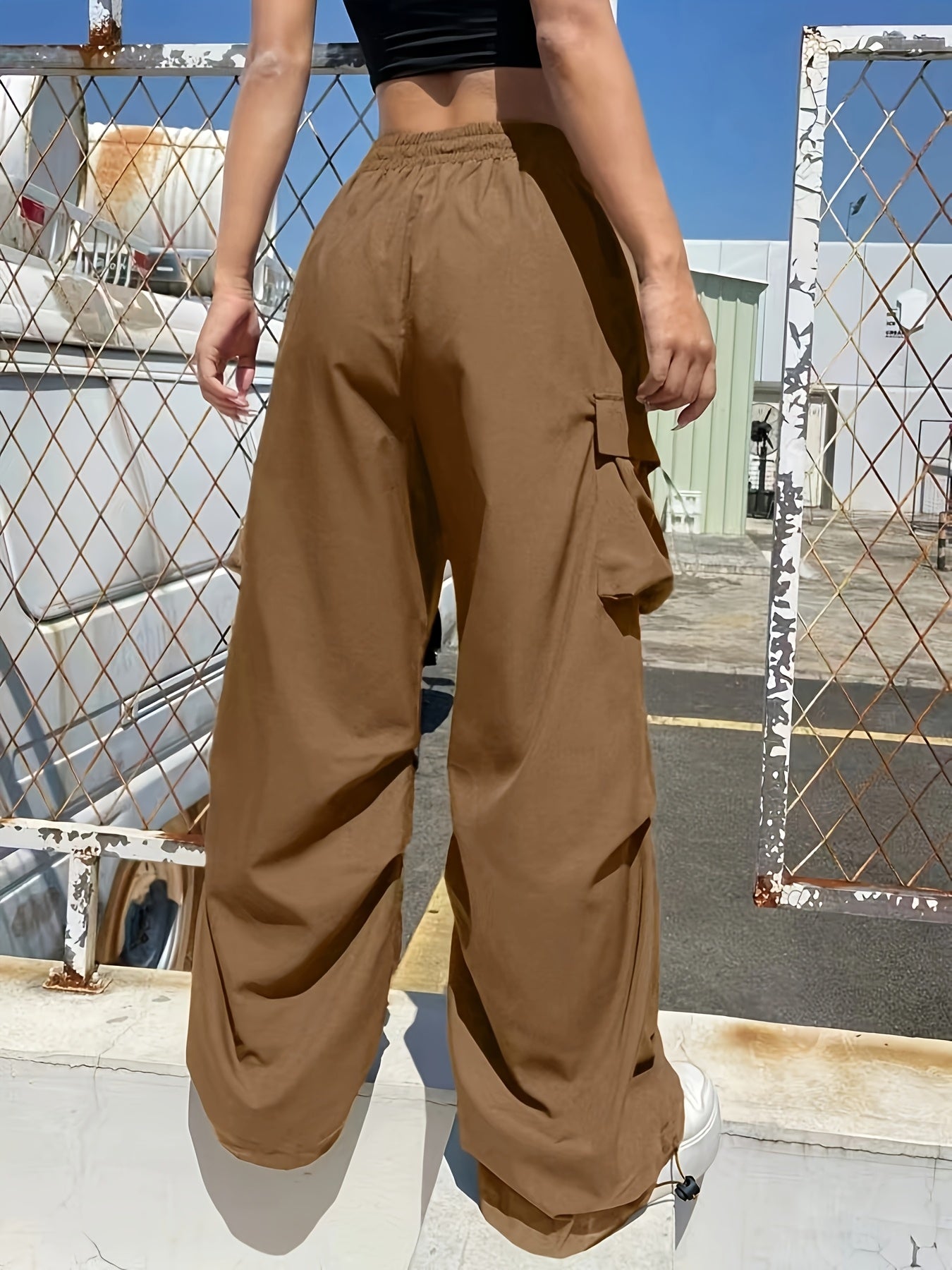 Women's loose-fit cargo parachute pants in ruby red with wide legs and multiple pockets, casual style by Jesie-London.