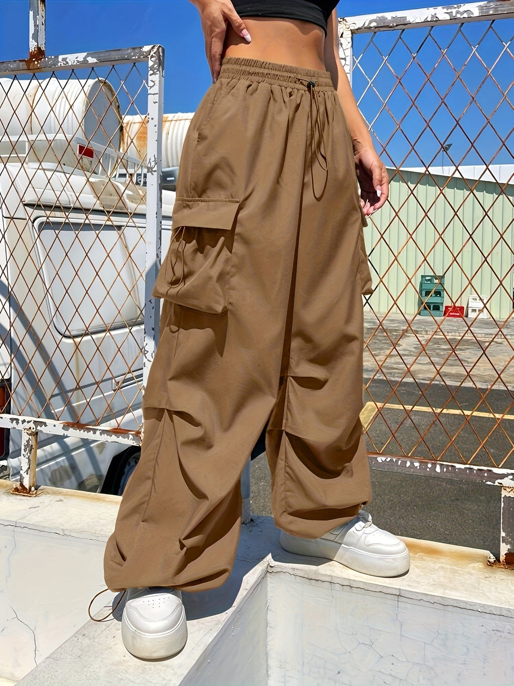 Women's wide-leg casual cargo pants by Jesie-London with large front pockets and a loose parachute fit, shown in beige.