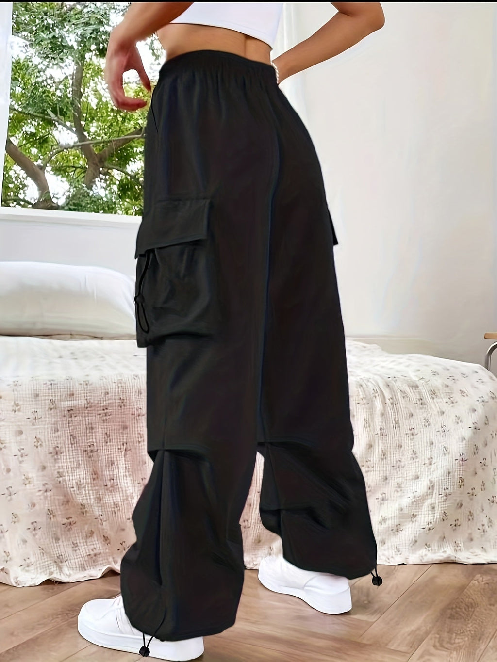 Women's wide-leg cargo pants by Jesie-London with large pockets, relaxed fit, and casual parachute-style design.