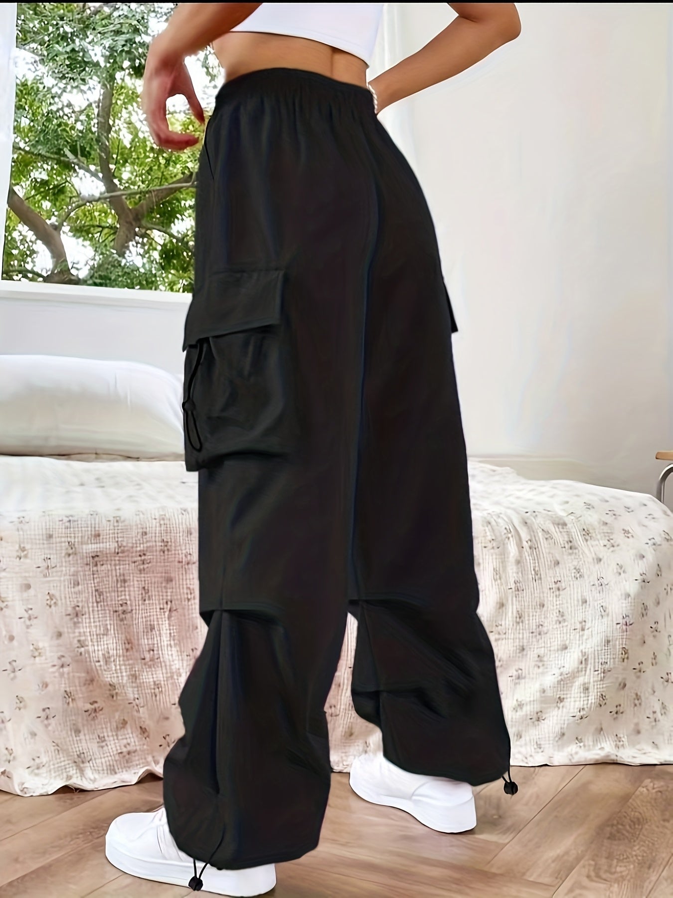 Women's wide-leg cargo pants by Jesie-London with large pockets, relaxed fit, and casual parachute-style design.