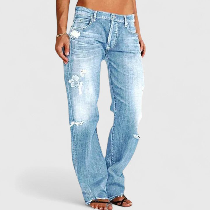 Women's distressed low-rise straight leg jeans by Jesie-London, featuring a relaxed fit and mid-rise denim style.