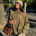 Women's cropped zip-up bomber jacket by Jesie-London, showing a stylish oversized design with a front zipper and fitted silhouette.