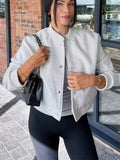 Women's cropped bomber jacket by Jesie-London with ribbed design and front snap buttons, in a stylish Jasmine color.