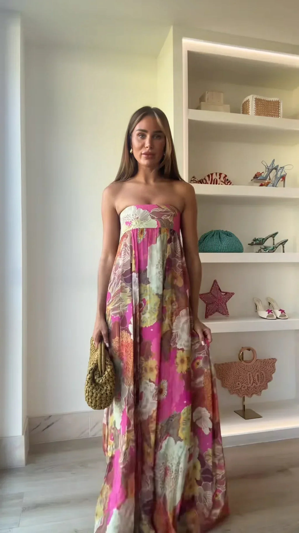 Jesie-London Ivy women's strapless floral maxi wedding guest dress with flowing fabric and vibrant flower pattern.